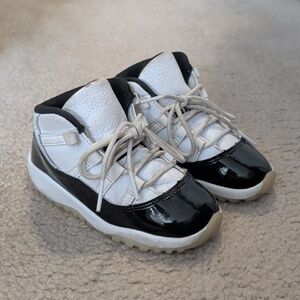 Jordan 11s Kids Black & White Patent Toe Sneakers